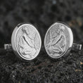 Load image into Gallery viewer, Polished silver Pensive Christ cufflinks are displayed on black volcanic rock in a premium macro studio close-up with detailed Christian devotional artwork.