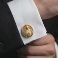 Load image into Gallery viewer, A gold plated Saint Francis cufflink is worn on a white cuff in a close-up lifestyle shot, styled as a thoughtful religious gift for Catholic men.