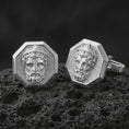 Load image into Gallery viewer, Polished silver Zeus cufflinks are displayed on black volcanic rock in a premium macro studio close-up with sharp facial texture and clean geometric edges.