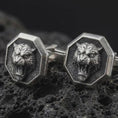 Load image into Gallery viewer, An oxidized tiger head cufflink pair rests on dark volcanic rock in a macro studio close-up, showing a fierce roaring big cat inside octagon frames.