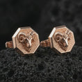 Load image into Gallery viewer, Rose gold plated ram head cufflinks are photographed on porous volcanic rock in a close-up studio composition with refined luxury lighting and strong ram features.