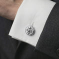 Load image into Gallery viewer, A polished silver octopus cufflink is worn on a shirt cuff in a premium close-up lifestyle image, showing the sculpted tentacles clearly.