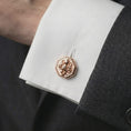 Load image into Gallery viewer, A rose gold plated octopus cufflink is worn on a shirt cuff in a close-up lifestyle composition, highlighting its octagon frame and sculpted octopus design.
