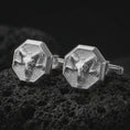 Load image into Gallery viewer, Polished silver ram skull cufflinks are displayed on black volcanic rock in a premium macro studio close-up with sharp horn texture and clean geometric edges.