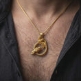Load image into Gallery viewer, Gold plated Hugin and Munin ravens pendant necklace worn on the chest, premium lifestyle jewelry photo with Odin’s ravens pendant centered on a spiga chain.