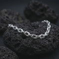 Load image into Gallery viewer, Polished silver anchor chain bracelet displayed on dark volcanic stone, emphasizing the clean oval link structure.