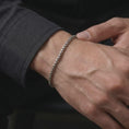 Load image into Gallery viewer, Polished sterling silver square link bracelet worn on the wrist, featuring a clean minimalist shape and refined chain detail.
