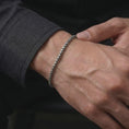 Load image into Gallery viewer, Oxidized silver box chain bracelet worn on a male wrist, showing its narrow fit and subtle vintage texture for everyday styling.
