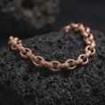 Load image into Gallery viewer, Rose gold plated vintage-style link bracelet displayed on volcanic stone, highlighting its open chain structure and decorative surface pattern.