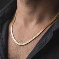 Load image into Gallery viewer, Gold plated snake chain necklace worn on a male model, presenting a clean warm-tone chain for simple everyday styling.