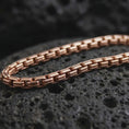 Load image into Gallery viewer, Rose gold plated box chain necklace shown on dark volcanic stone, with warm metal tone and defined rectangular link details.