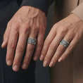 Load image into Gallery viewer, An oxidized dragon scale ring is worn on a man’s and woman’s fingers, displaying the dark recessed scales and raised silver claws in a close-up matching couple lifestyle shot.