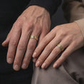 Load image into Gallery viewer, Gold plated geometric lattice rings are worn on a man’s and woman’s fingers, highlighting the matching engraved pattern as a distinctive couple or wedding band set.
