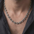 Load image into Gallery viewer, An 11mm mariner chain necklace with an oxidized finish is worn around a man’s neck, displaying the darkened recesses and bold anchor-inspired links in a masculine lifestyle close-up.