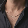 Load image into Gallery viewer, The rose gold plated rope chain necklace is worn naturally on a man’s chest, showcasing the twisted sterling silver structure, warm finish, and elegant masculine jewelry design.