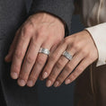 Load image into Gallery viewer, The polished silver ornate wedding band is worn naturally on a finger, showing the continuous scrollwork pattern and smooth unisex spinner ring profile in a premium lifestyle photograph.