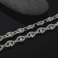 Load image into Gallery viewer, The polished silver 11mm Mariner chain necklace is displayed on textured black volcanic rock, highlighting the smooth puffed anchor links, reflective sterling silver surfaces, and bold wide-link construction in a premium macro photograph.