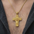Load image into Gallery viewer, A gold plated Pope Francis cross pendant is worn on the chest, highlighting the Good Shepherd scene, flock symbolism, dove motif, and distinctive Catholic faith jewelry design in a refined close-up lifestyle shot.