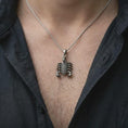 Load image into Gallery viewer, An oxidized silver Scorpio pendant is worn naturally on the chest, displaying the detailed scorpion anatomy, dark recessed textures, raised silver surfaces, and bold animal totem profile in a close-up lifestyle image.