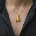 Load image into Gallery viewer, A gold plated scorpion necklace is worn on the chest, highlighting the segmented body, prominent pincers, curved tail, and distinctive Scorpio zodiac jewelry design in a refined lifestyle photograph.