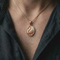 Load image into Gallery viewer, The rose gold plated swan necklace is worn on the chest, showcasing the elegant swan form, sculptural wings, curved neck, and meaningful love and devotion symbolism in a premium lifestyle image.