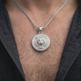 Load image into Gallery viewer, Polished silver roaring tiger pendant worn on the chest, featuring a fierce wild cat face, sculpted fur details, open mouth, and decorative medallion border.