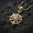 Load image into Gallery viewer, Gold plated Gale's Earring inspired necklace on black volcanic rock, featuring an eight-point magical star design and brilliant clear center stone.