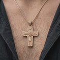 Load image into Gallery viewer, The rose gold plated Good Shepherd cross necklace is worn on the chest, showcasing the sculptural shepherd figure, surrounding sheep, dove symbol, and elegant Christian devotional jewelry design.