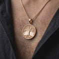 Load image into Gallery viewer, The rose gold plated Tree of Life pendant is worn on the chest, showcasing the circular medallion, intricately sculpted branches, delicate leaves, intertwined roots, and elegant nature-inspired jewelry design.