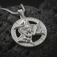 Load image into Gallery viewer, Polished sterling silver Sicilian Triskelion necklace on volcanic stone, showing the Medusa centerpiece, three-legged Trinacria design, and circular Greek key frame.