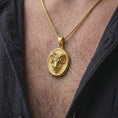 Load image into Gallery viewer, Gold plated Aries ram necklace worn on the chest, highlighting the powerful horned ram design, oval medallion shape, and meaningful astrology-inspired styling.
