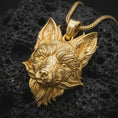 Load image into Gallery viewer, Gold plated fox head pendant resting on black volcanic rock, featuring a detailed fox portrait, pointed ears, sculpted muzzle, and bold woodland-inspired jewelry design.