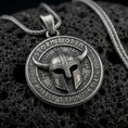 Load image into Gallery viewer, Oxidized sterling silver Viking helmet pendant on black volcanic rock, featuring a horned warrior helmet, Storm and Odin lettering, and Norse-inspired rune symbols.
