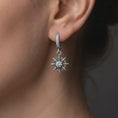 Load image into Gallery viewer, Oxidized finish over sterling silver Gale inspired single earring worn on the ear, featuring an eight-point starburst charm with a clear faceted center stone, inspired by Baldur’s Gate 3 wizard jewelry.