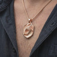 Load image into Gallery viewer, Rose gold plated eagle shield pendant worn on the chest, showcasing the bird of prey design, sculpted feathers, curved claws, and meaningful statement jewelry style.