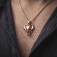 Load image into Gallery viewer, Rose gold plated elephant head pendant worn on the chest, showcasing the realistic elephant face, broad ears, curved tusks, and distinctive animal necklace design.