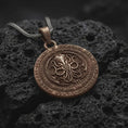 Load image into Gallery viewer, Bronze Cthulhu pendant on black volcanic rock, featuring a raised cephalopod sigil in the center, engraved outer ring lettering, and a dark Lovecraftian medallion design.