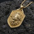Load image into Gallery viewer, Gold plated regal lion pendant resting on black volcanic rock, featuring a majestic lion head, layered mane, textured background, and bold heraldic shield silhouette.