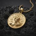 Load image into Gallery viewer, Gold plated Memento Mori pendant resting on black volcanic rock, featuring a sculpted human face transitioning into a skull, cracked textures, Roman clock numerals, and symbolic mortality artwork.