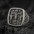 Load image into Gallery viewer, Oxidized sterling silver Crucifixion ring on black volcanic rock, featuring Jesus Christ on the center cross between the two thieves, INRI inscription, and detailed Calvary scene.