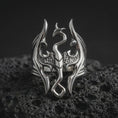 Load image into Gallery viewer, Polished sterling silver Elder Scrolls dragon ring displayed on dark volcanic stone, highlighting the sculpted Imperial Dragon crest, sharply pointed wings, curved tail, and intricate three-dimensional silver detailing.