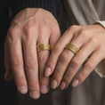 Load image into Gallery viewer, Gold plated 925 sterling silver matching Norse Valknut rings worn on the fingers of a man and woman together, featuring raised Viking triangle symbols, textured geometric backgrounds, and coordinated warm gold finishes.