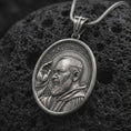 Load image into Gallery viewer, Oxidized sterling silver Padre Pio pendant on black volcanic rock, featuring Saint Pio of Pietrelcina with a raised blessing hand, detailed beard, halo, and traditional Franciscan habit.