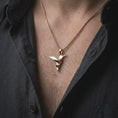 Load image into Gallery viewer, Rose gold plated origami hummingbird charm worn on the chest, showcasing the geometric bird form, sculptural pointed wings, and elegant minimalist necklace design.