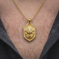 Load image into Gallery viewer, Gold plated lion shield necklace worn on the chest, highlighting the roaring lion head, detailed mane, fierce expression, and symbolic strength-inspired Leo zodiac jewelry aesthetic.
