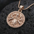 Load image into Gallery viewer, Rose gold plated knight protector necklace displayed on textured volcanic stone, showcasing the medieval knight embracing two children, sculpted armor, sword, and symbolic family protection design.