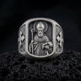 Load image into Gallery viewer, Oxidized 925 sterling silver Saint Nicholas of Myra signet ring displayed on textured black volcanic rock, featuring a bearded bishop with a mitre, crozier, book with three symbolic balls, ornate vestments, and dark oxidized silver finish.