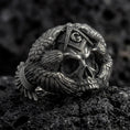 Load image into Gallery viewer, Oxidized sterling silver Masonic skull ring on black volcanic rock, featuring a detailed skull, Freemason Square and Compasses emblem with the letter G, and intricately sculpted eagle wings.