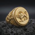 Load image into Gallery viewer, Gold plated Shir o Khorshid signet ring resting on black volcanic rock, featuring the historic Iranian lion and sun symbol, raised sword-bearing lion, radiant sun, and detailed circular rope-edge frame.