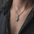 Load image into Gallery viewer, Oxidized sterling silver stag beetle necklace worn on the chest, showing the prominent beetle relief, dark recessed shield background, detailed insect legs, and distinctive gothic entomology jewelry design.